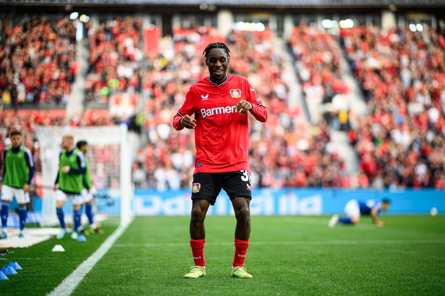  Bayer Leverkusen's Jeremie Frimpong celebrates scoring a goal during a Bundesliga match.