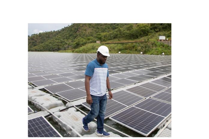 An engineer conducting routine inspection of the floating solar panel at Bui Power Authority. Photo Credit - USAID.