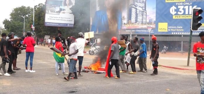 Protesters burning car tyres in the middle of the road to frustrate commuters.